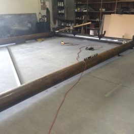 large steel canopy laid out in shop